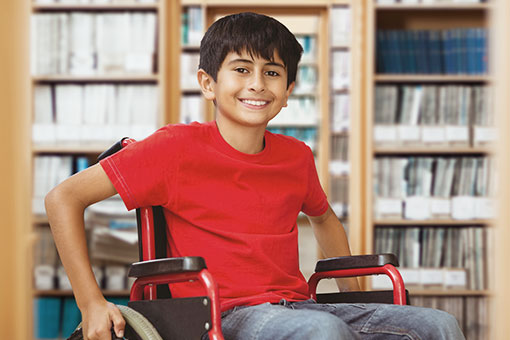 boy in wheelchair at a library